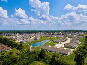 Dayton apartment for rent - A bird's eye view of a residential area with houses, a swimming pool, and a winding road.
