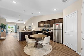 Dayton apartment for rent - A modern kitchen with a dining table and chairs.