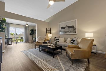 Dayton apartment for rent - A living room with a brown leather chair and a grey and white rug.