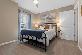 Dayton apartment for rent - A bedroom with a bed, nightstand, and a painting on the wall.