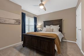 Midland apartment for rent - A bedroom with a large bed and a ceiling fan.