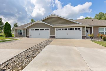 Milford apartment for rent - A house with a grey roof and two garages.