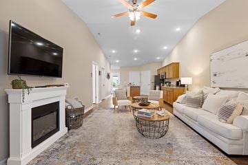 Milford apartment for rent - A living room with a fireplace and a television mounted on the wall.