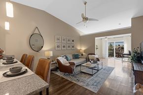 Monroe apartment for rent - A modern dining room with a table set for six and a fan on the ceiling.
