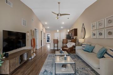 Monroe apartment for rent - A living room with a white couch and a wooden floor.