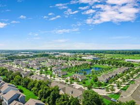 New Albany apartment for rent - A bird's eye view of a residential neighborhood with houses, trees, and a lake.