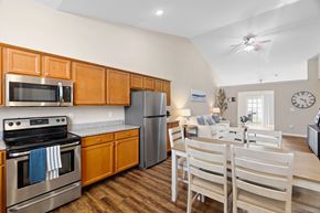 New Albany apartment for rent - A kitchen with wooden cabinets and a stainless steel oven.
