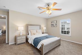 New Albany apartment for rent - A bedroom with a bed, nightstands, and a ceiling fan.
