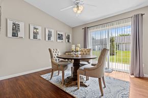 Newark apartment for rent - A dining room with a table set for four and a view of the backyard.