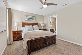 Newark apartment for rent - A bedroom with a large bed and a ceiling fan.