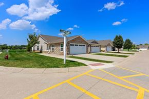 Noblesville apartment for rent - A street view of a residential area with houses and a street sign.