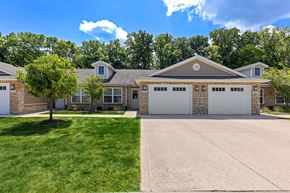 Noblesville apartment for rent - A large house with a driveway in front.