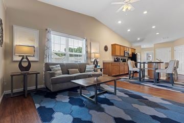Noblesville apartment for rent - A living room with a grey couch and a blue rug.