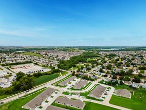 Omaha apartment for rent - A bird's eye view of a residential area with houses and green spaces.