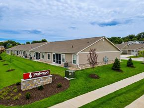 Omaha apartment for rent - A building with a sign that says Redwood in front of it.