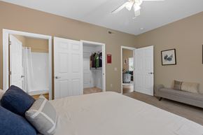 Oregon apartment for rent - A bedroom with a large bed and a ceiling fan.