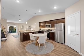 Oswego apartment for rent - A modern kitchen with a dining table and chairs.