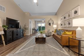 Oswego apartment for rent - A living room with a brown sofa and a coffee table.