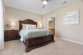 Pataskala apartment for rent - A bedroom with a large bed and a painting on the wall.