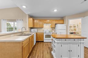 Perrysburg apartment for rent - A kitchen with wooden cabinets and a white fridge.