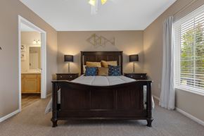 Perrysburg apartment for rent - A bedroom with a large bed and two lamps.