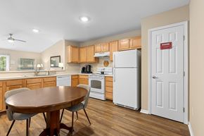 Perrysburg apartment for rent - A kitchen with a table and chairs and a refrigerator.