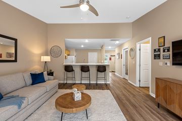 Perrysburg apartment for rent - A living room with a grey sofa and a wooden coffee table.