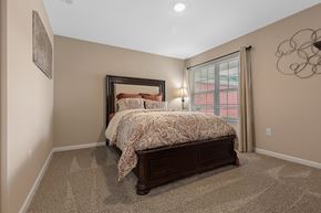 Perrysburg apartment for rent - A bedroom with a large bed and a window with curtains.