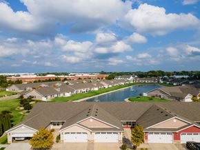 Perrysburg apartment for rent - A suburban neighborhood with houses and a pool.