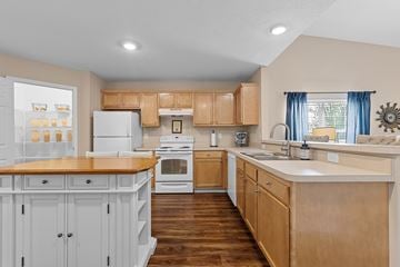 Perrysburg apartment for rent - A kitchen with wooden cabinets and a white refrigerator.