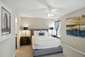 Plainfield apartment for rent - A bedroom with a large bed and a ceiling fan.