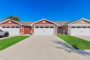Portage apartment for rent - A row of garages with a car parked in the first one.