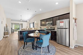 Portage apartment for rent - A kitchen with a table and chairs in the middle of the room.