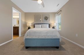 Portage apartment for rent - A bedroom with a large bed and a ceiling fan.