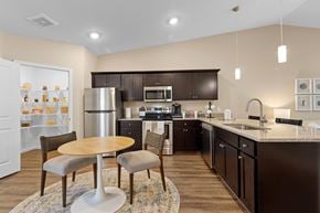 Batavia apartment for rent - A kitchen with brown cabinets and a white refrigerator.