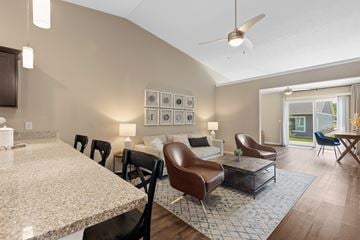 Batavia apartment for rent - A modern living room with a marble table and brown leather chairs.