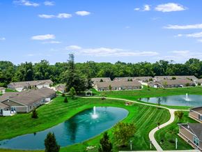 Reynoldsburg apartment for rent - A residential area with a fountain in the middle of a grassy area.