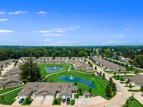 Reynoldsburg apartment for rent - A bird's eye view of a residential neighborhood with houses, a pond, and a playground.