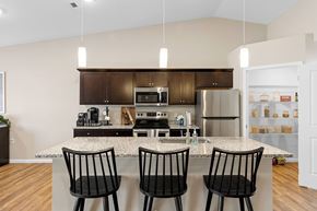 Rochester Hills apartment for rent - A kitchen with brown cabinets and a granite countertop.