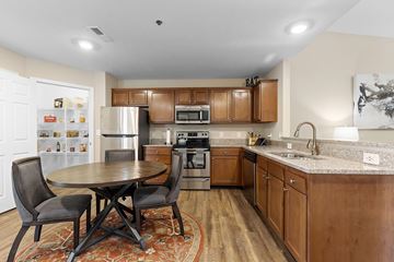 Shelby Twp apartment for rent - A kitchen with a table and chairs in the middle of the room.