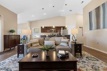 Simpsonville apartment for rent - A modern living room with a dark wood coffee table and a large painting on the wall.