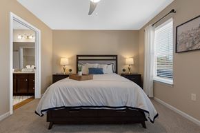 Simpsonville apartment for rent - A bedroom with a large bed and a ceiling fan.