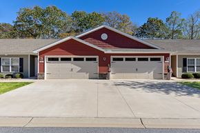 Simpsonville apartment for rent - A two-car garage with a red brick exterior and a grey roof.