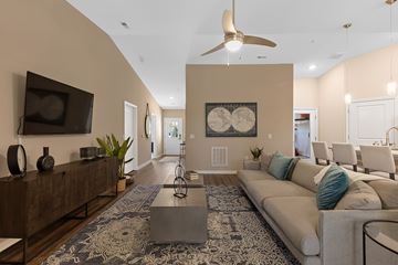 Simpsonville apartment for rent - A living room with a white couch and a rug.