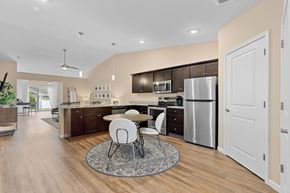 South Lebanon apartment for rent - A modern kitchen with a dining table and chairs in the middle.