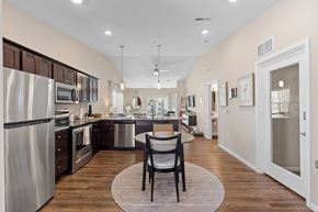 Southgate apartment for rent - A modern kitchen with a dining table and chairs in the middle.