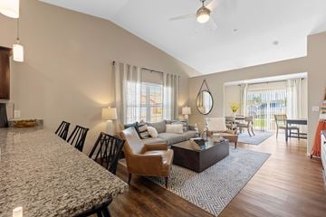 Southgate apartment for rent - A living room with a marble table and a hanging circular mirror.