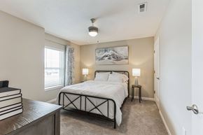 Southgate apartment for rent - A bedroom with a large bed and a painting on the wall.