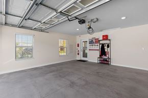 Southgate apartment for rent - A spacious room with a concrete floor and a ceiling with exposed pipes.