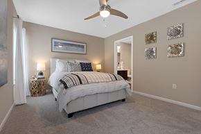 Sugarcreek Township apartment for rent - A bedroom with a large bed and a ceiling fan.